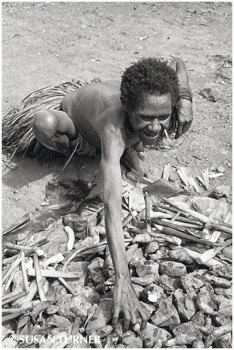 An Anga Woman at Her Earth Oven